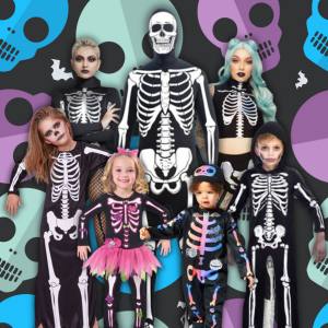 Image of 3 adults and 4 kids all wearing different skeleton costumes.