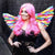 Image of a woman wearing a pair of rainbow angel wings.