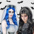 Image of a woman and a girl wearing different Halloween themed wigs, one is the Corpse Bride wig in blue and the other a black with with grey streaks.