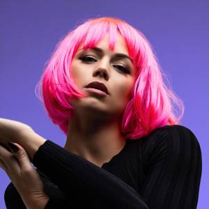 Image of a woman wearing a neon pink costume wig