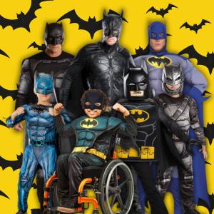 Image of men and boys wearing Batman costumes