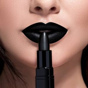 Image of a woman applying black lipstick