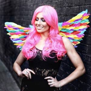 Image of a woman wearing rainbow costume wings