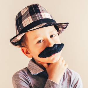 Image of a boy with a fake moustache on