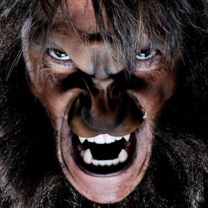 Image of a man wearing werewolf costume teeth