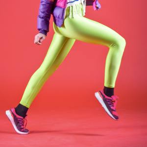 Image of a woman wearing green footless leggings