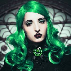 Image of a woman wearing a curly, green costume wig