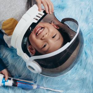 Image of a boy wearing an astronaut helmet