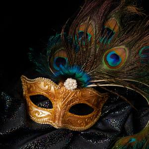 Image of a gold masquerade mask with peacock feathers attached