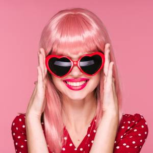 Image of a woman wearing heart shaped costume glasses