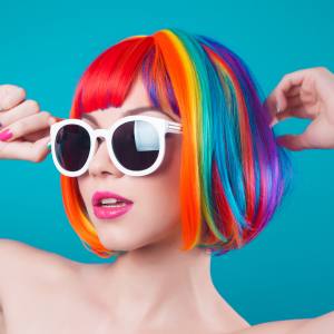 Image of a woman wearing a rainbow bob wig