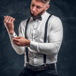 Image of a man wearing a bow tie, suspenders and a belt