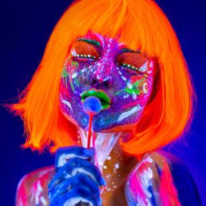 Image of a woman wearing UV reactive and glow in the dark makeup