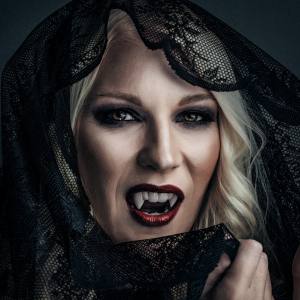 Image of a woman wearing vampire fangs