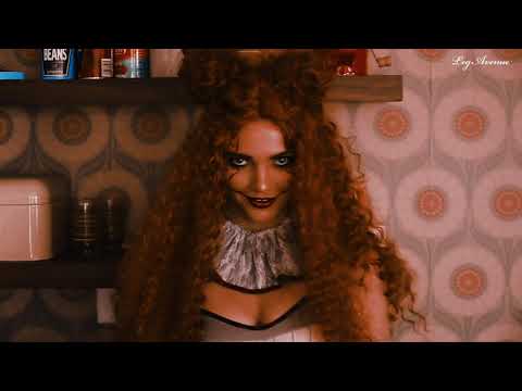 A video of a woman modelling a sexy Pennywise costume and this long curly ginger costume wig by the brand Leg Avenue.